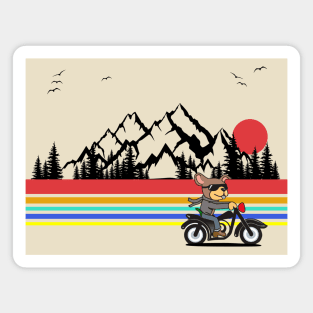 Dog riding a motorcycle with a mountain backdrop and sunset Magnet